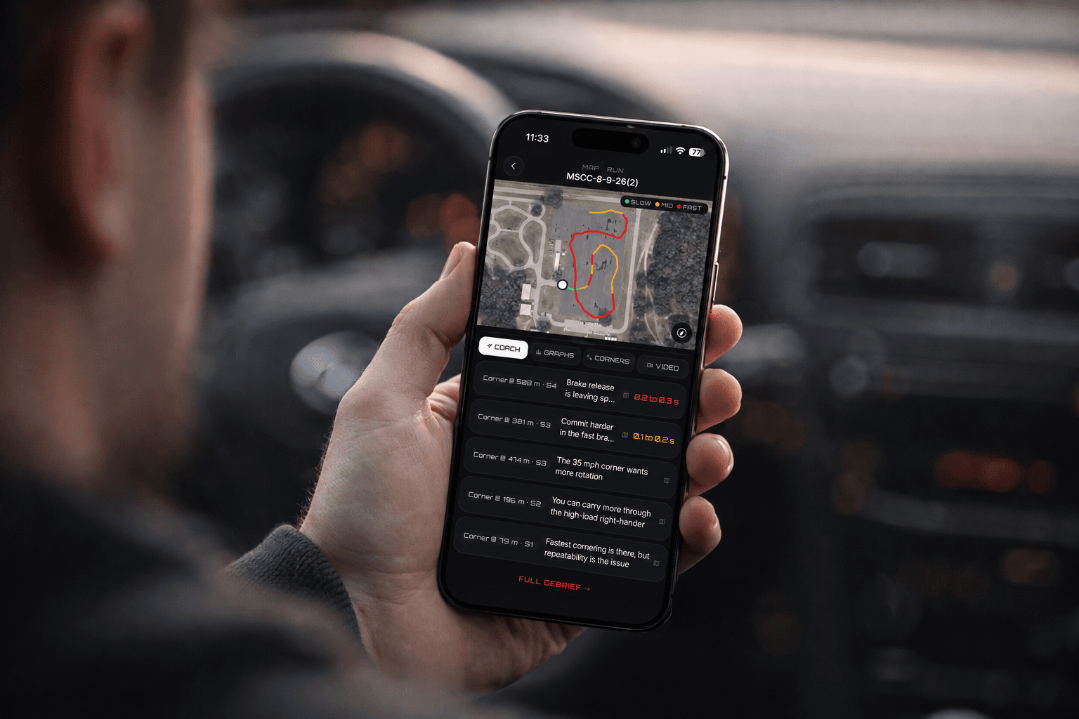 A DriverMod session debrief open on a phone, held in a car